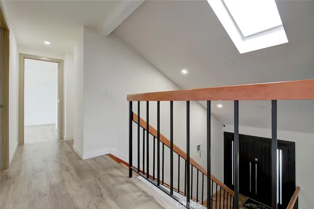 a view of a hallway with wooden floor