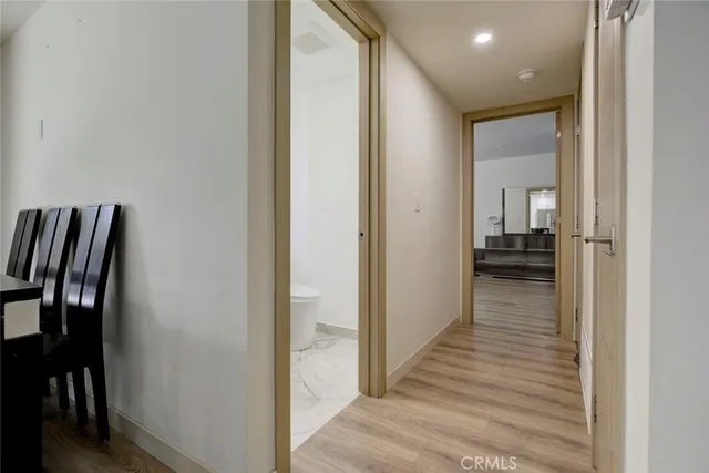 a view of a hallway with wooden floor and staircase