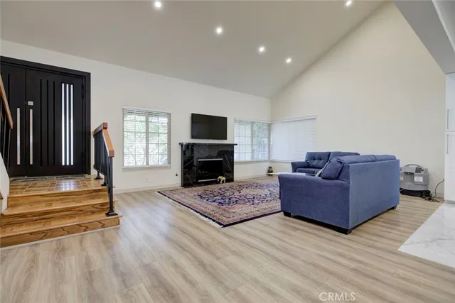 a living room with furniture and a fireplace