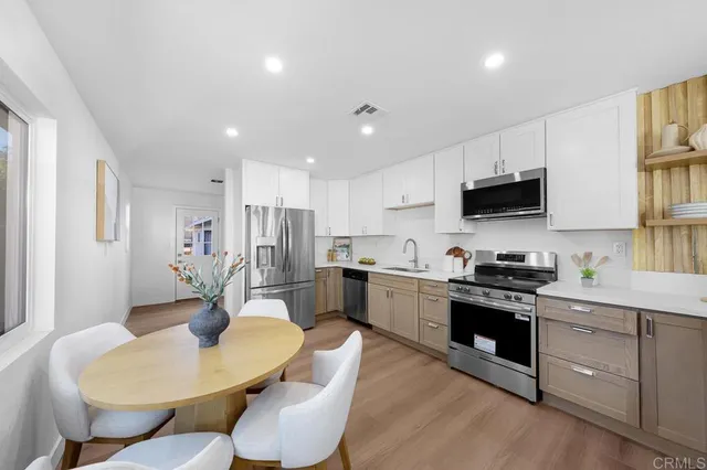 a bedroom with a bed and a potted plant