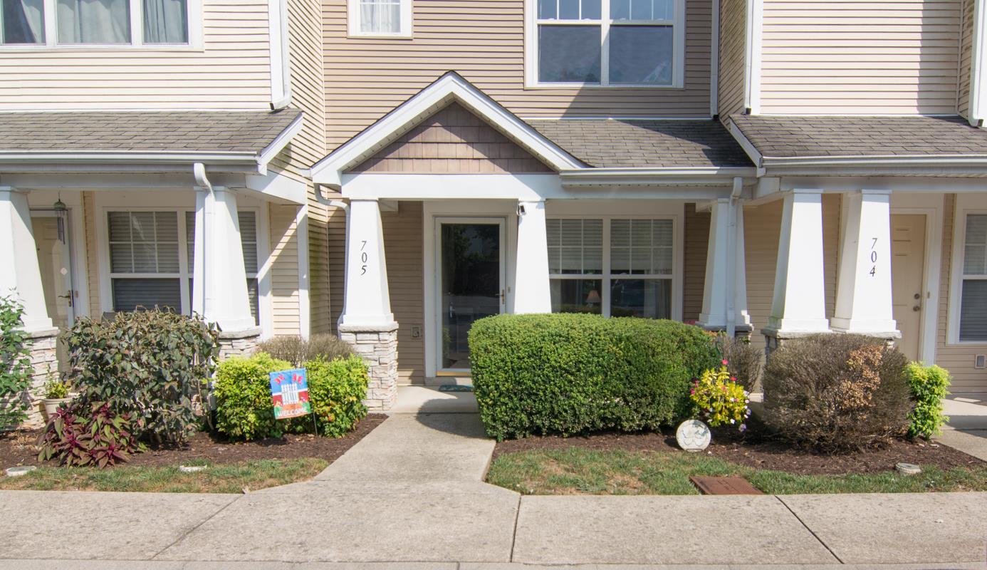 a view of a brick house with potted plants