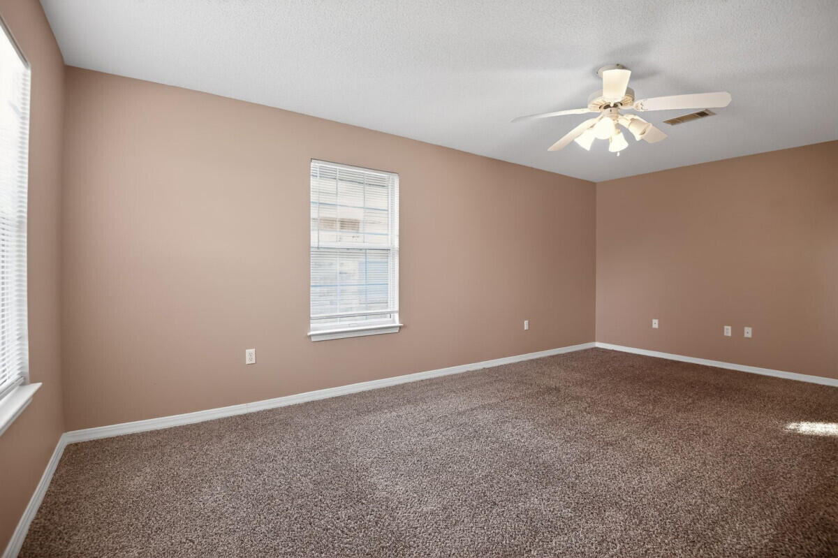 4654 Sunsail Circle Destin, FL 32541 - Photo 18 of 22 an empty room with windows and fan