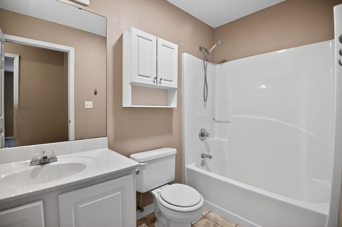 4654 Sunsail Circle Destin, FL 32541 - Photo 19 of 22 a bathroom with a granite countertop sink a toilet and shower