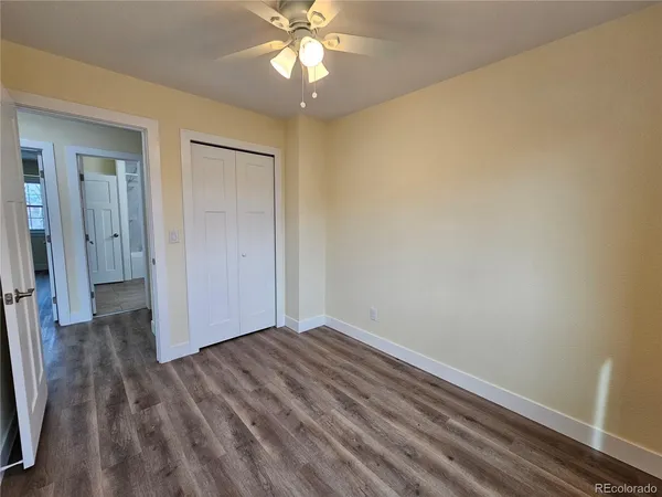 a view of room with hardwood floor and ceiling fan