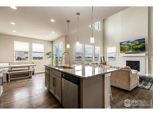a kitchen with kitchen island granite countertop a sink counter top space and stainless steel appliances