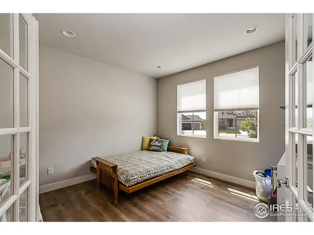 a living room with a bed furniture and a window