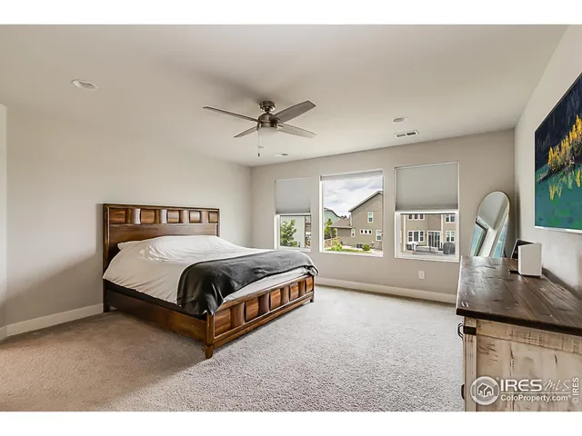 a spacious bedroom with a bed and a window
