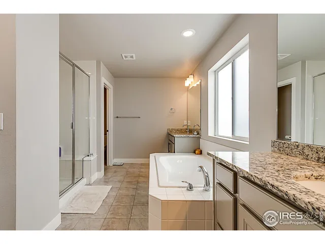a bathroom with a sink a toilet and large mirror