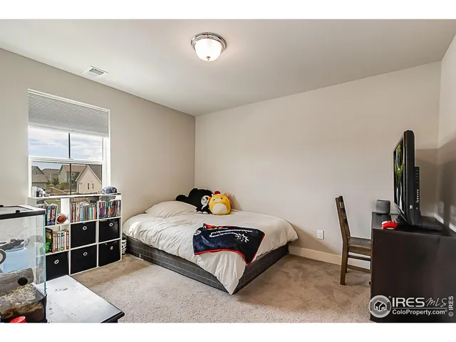 a bedroom with a bed and flat screen tv