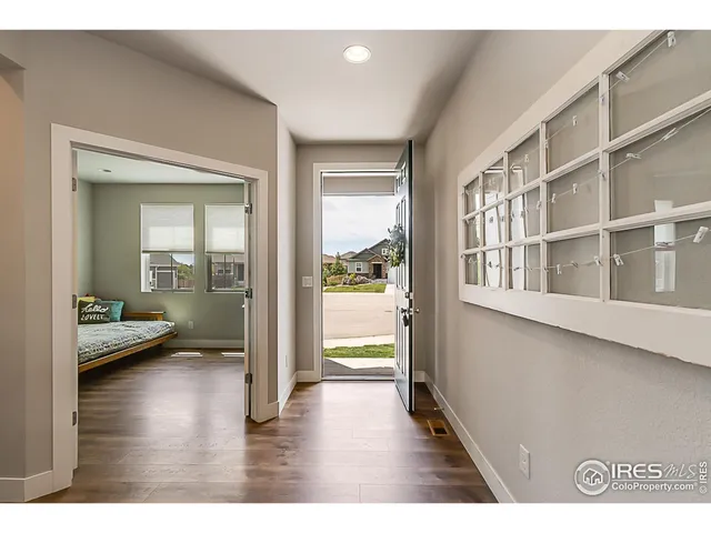 a hallway with a wooden floor and a table