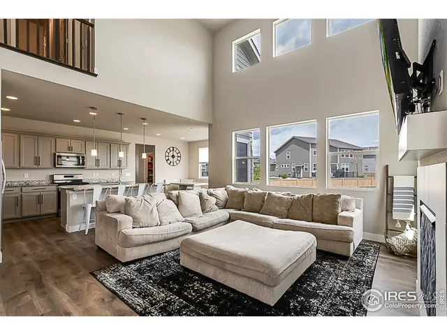 a living room with furniture and a view of kitchen