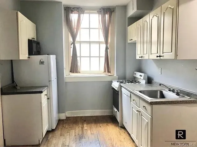 a kitchen that has a sink and a stove