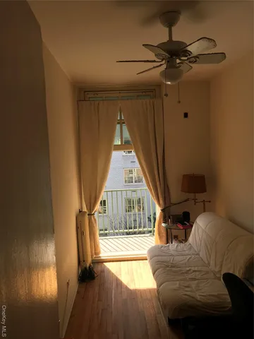 a living room with furniture and a floor to ceiling window