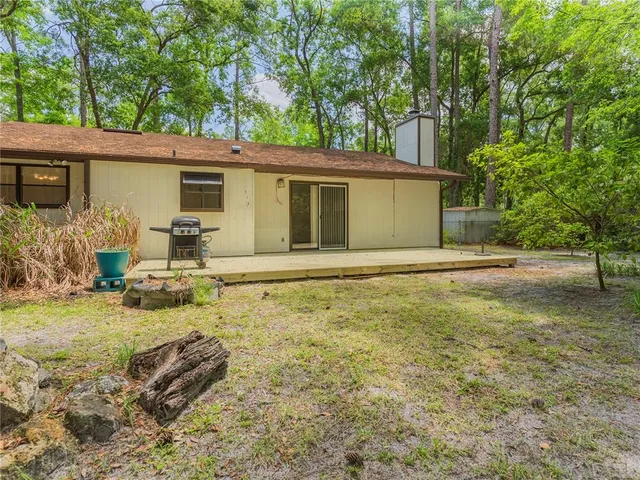a backyard of a house with yard and outdoor seating