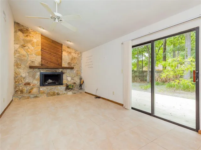 a view of empty room with fireplace and window