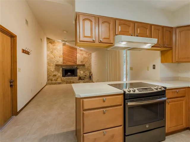a kitchen with granite countertop a stove and a cabinet