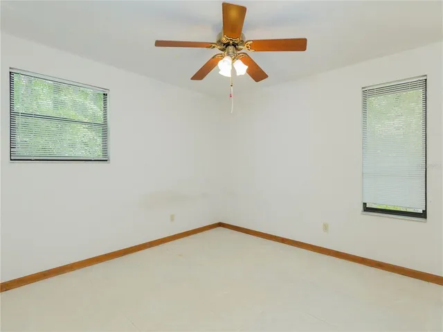 a view of a room with a fan and a window