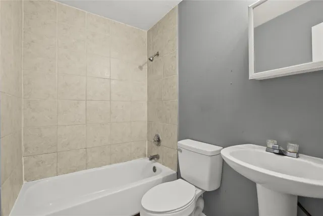 a bathroom with a sink toilet and bathtub