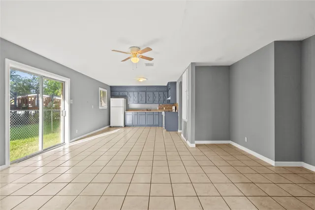 a view of empty room with wooden floor and fireplace