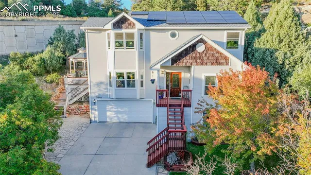 a aerial view of a house with a yard and potted plants