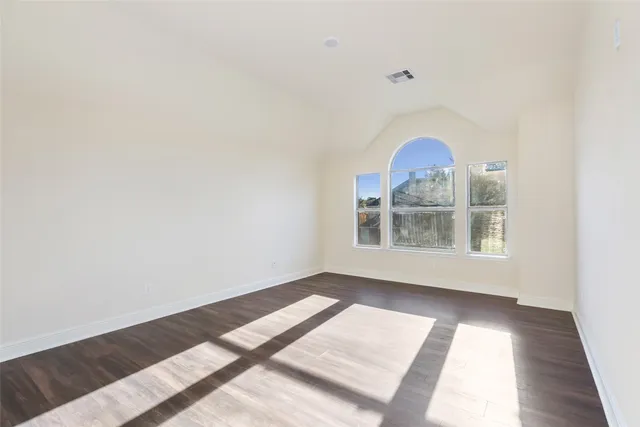 a view of a livingroom with wooden floor and stairs