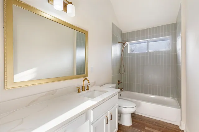 an empty room with wooden floor cabinet and windows