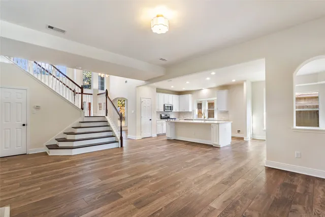 a kitchen with stainless steel appliances a sink stove and cabinets