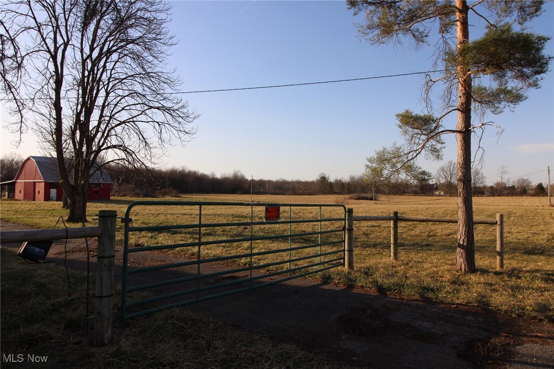 8094 South Pricetown Road Berlin Center, OH 44401 - Photo 7 of 7 View of gate featuring an outbuilding, a barn, fence, a yard, and a rural view