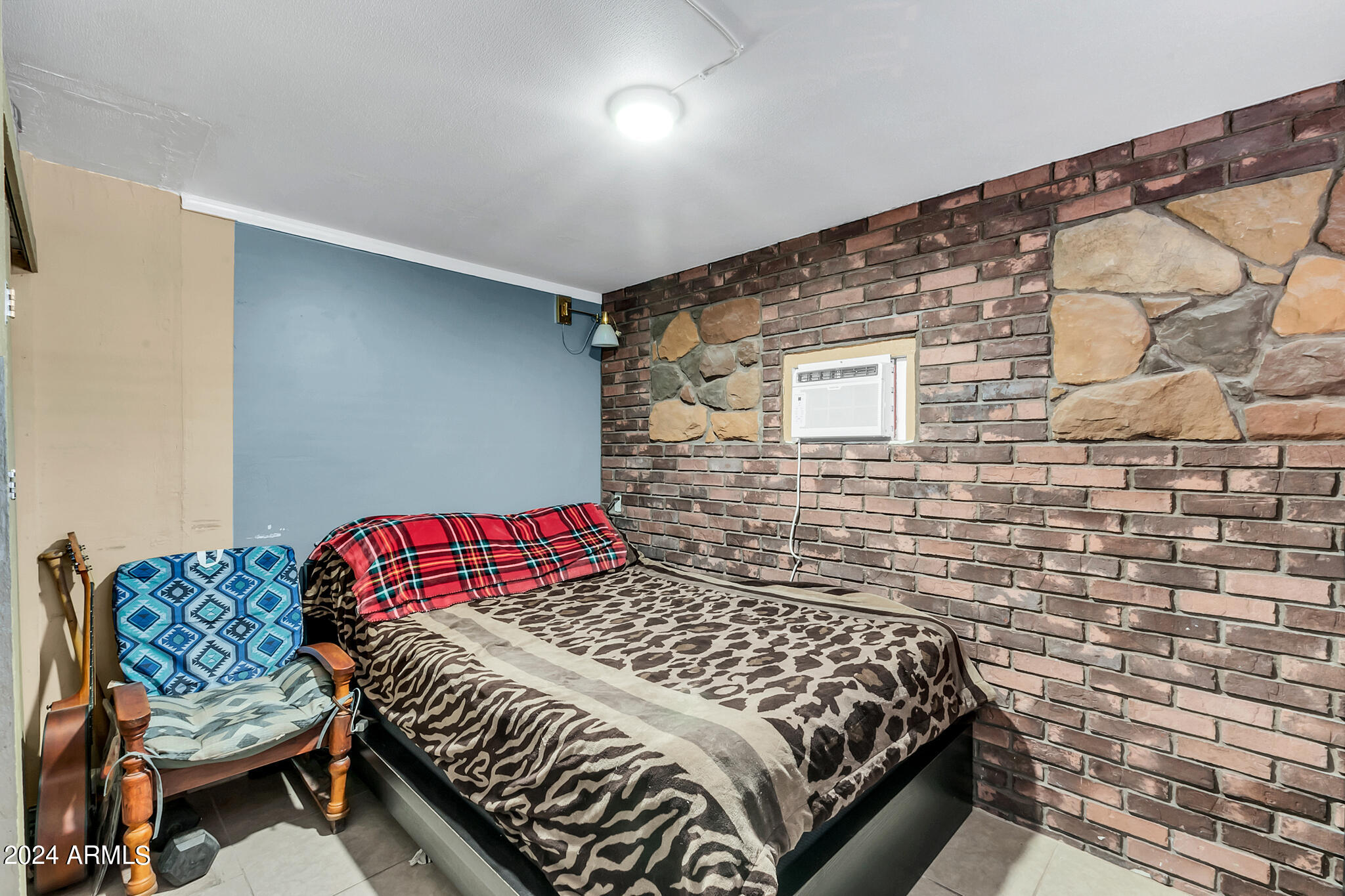 130 East McKellips Road, Unit 48 Mesa, AZ 85201 - Photo 12 of 24 a bedroom with a bed and a chair with the wooden floor