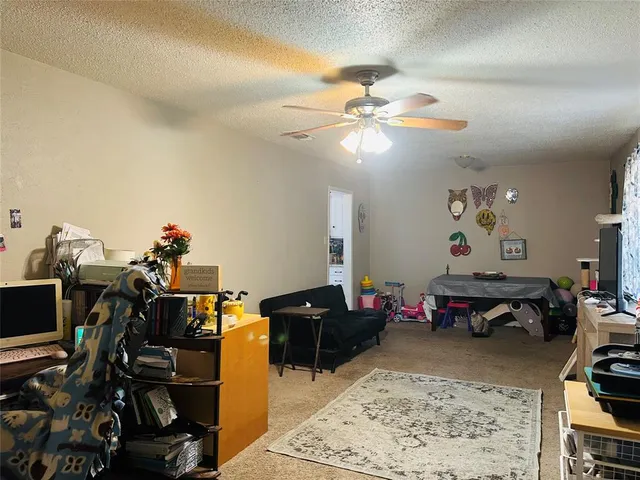 a living room with furniture a flat screen tv and a window