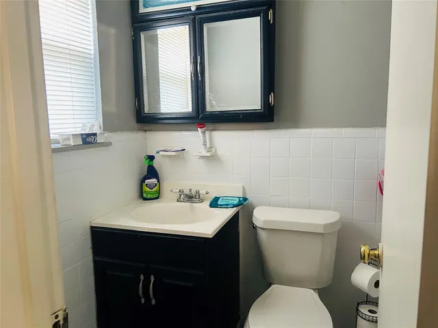 a bathroom with a toilet sink and mirror