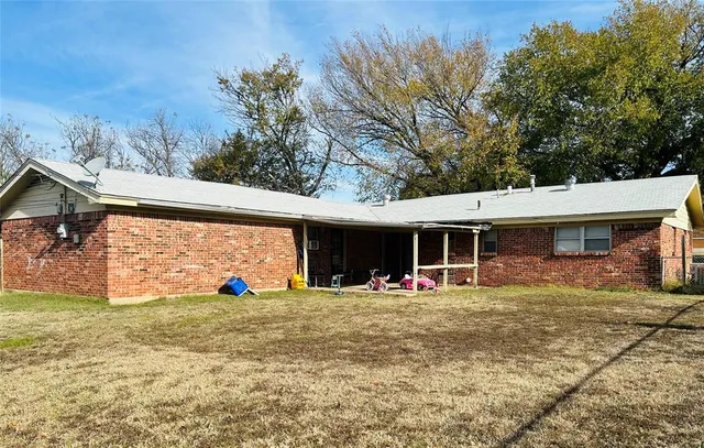 a view of a house with a backyard porch and sitting area