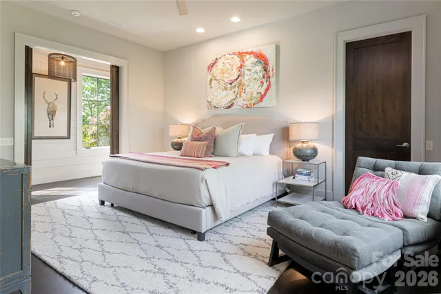 a bedroom with a bed and a painting on the wall