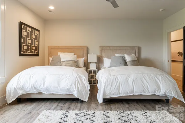 a bedroom with two beds and painting on the wall