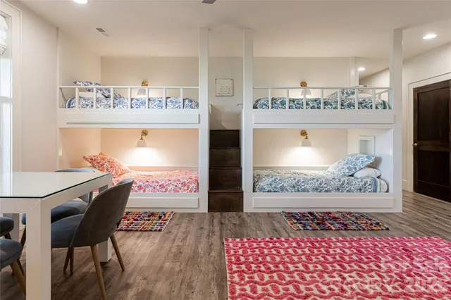 a view of a kitchen with refrigerator and wooden floor