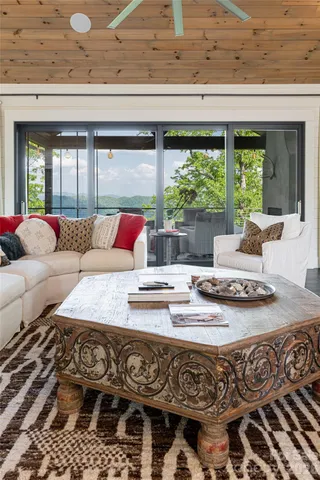 a living room with furniture and a floor to ceiling window