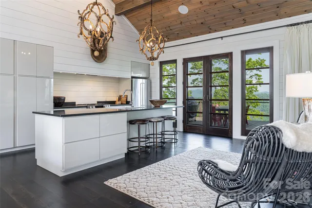 a kitchen with a chandelier dining table and chairs