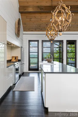 a kitchen with stainless steel appliances granite countertop a stove and cabinets