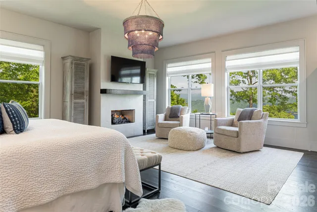 a bedroom with a bed and a chandelier