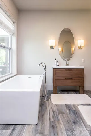 a living room with a bed furniture and a large window