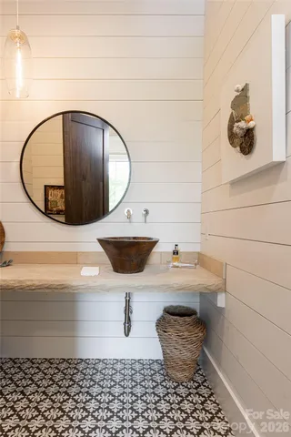 a bathroom with a sink and mirror