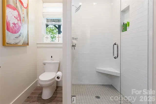 a bathroom with a toilet and a shower