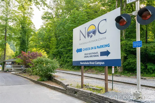 a view of a house with a big yard and large trees