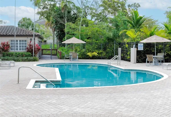 a view of house with swimming pool and chair
