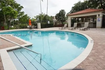 a view of a swimming pool with chairs