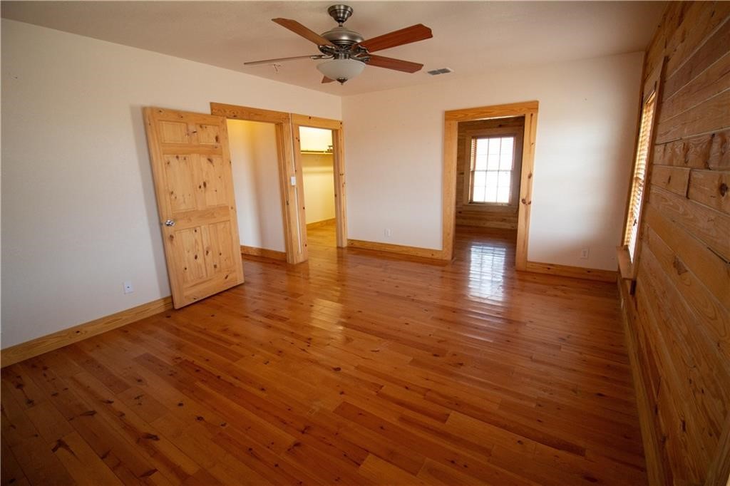 11701 Highway 359 Mathis, TX 78368 - Photo 13 of 35 an empty room with wooden floor and windows