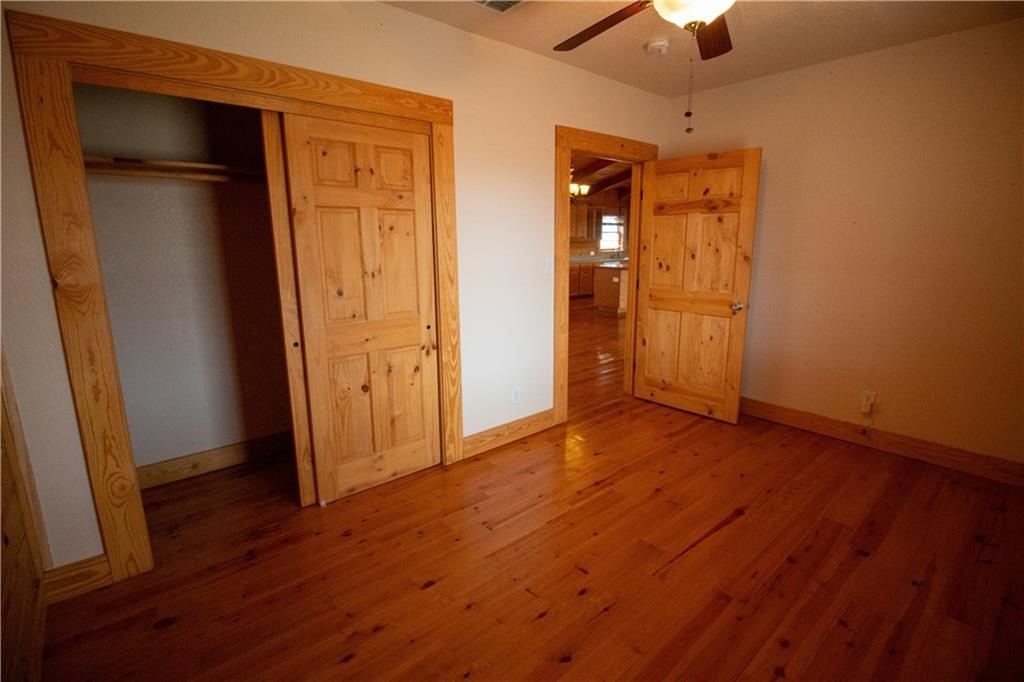 11701 Highway 359 Mathis, TX 78368 - Photo 15 of 35 an empty room with wooden floor and closet area