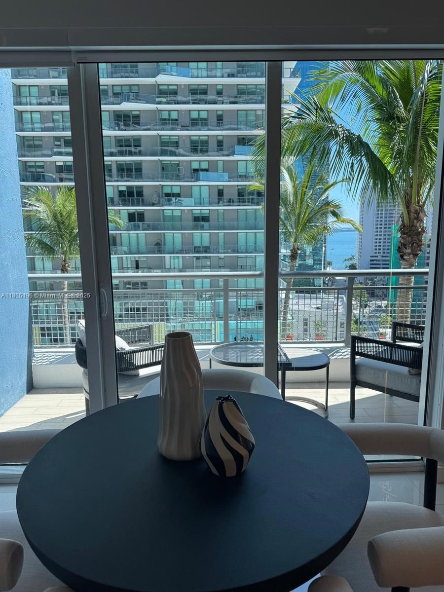 60 Southwest 13th Street, Unit 1406 Miami, FL 33130 - Photo 1 of 19 a view of a dining room with furniture window and outside view