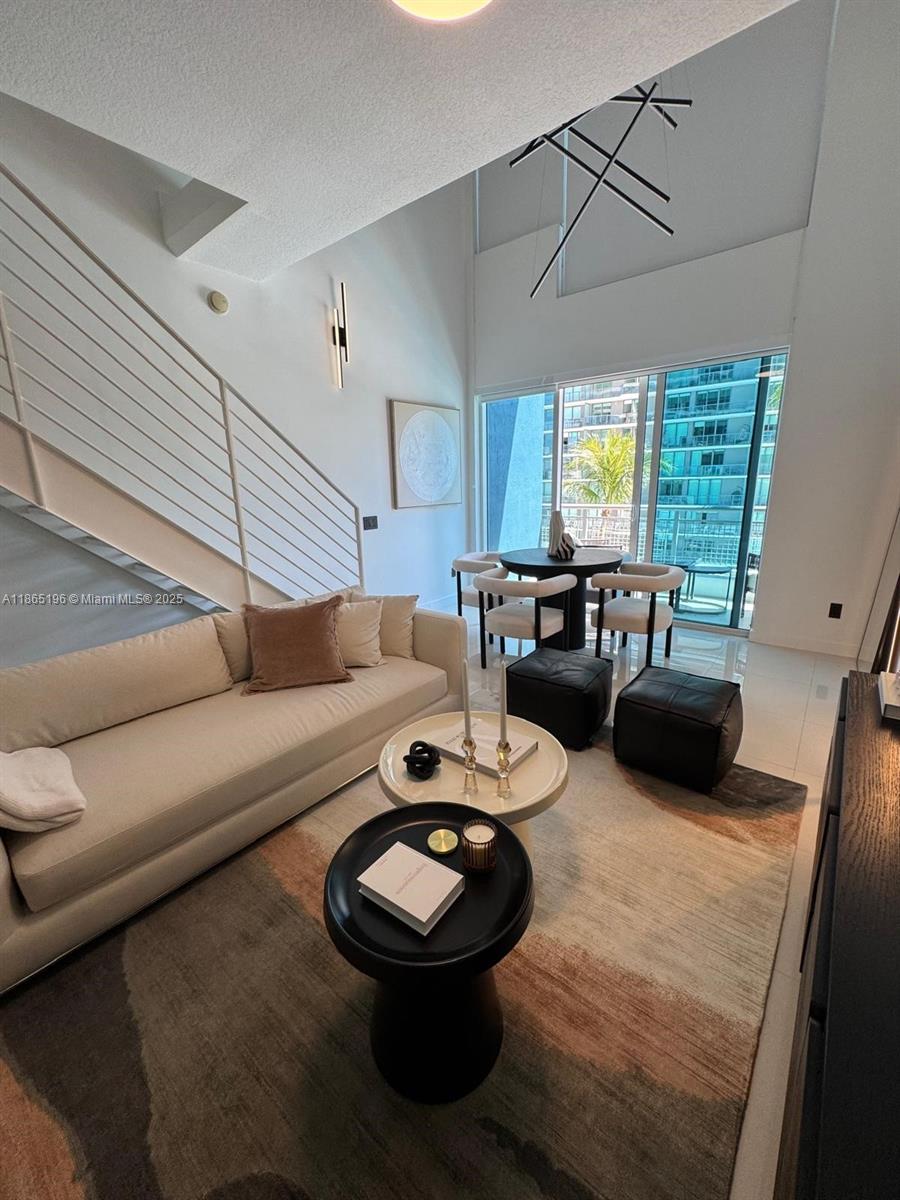 60 Southwest 13th Street, Unit 1406 Miami, FL 33130 - Photo 14 of 19 a living room with furniture and a large window