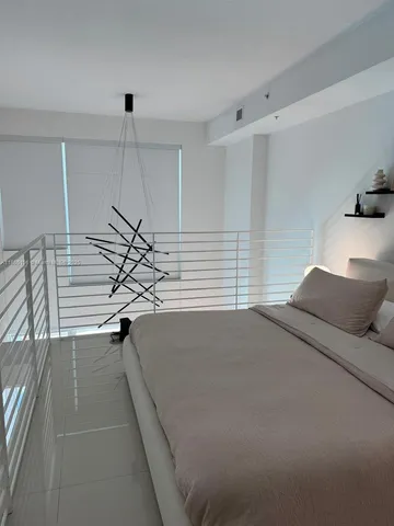 a bedroom with a bed and a walk in closet